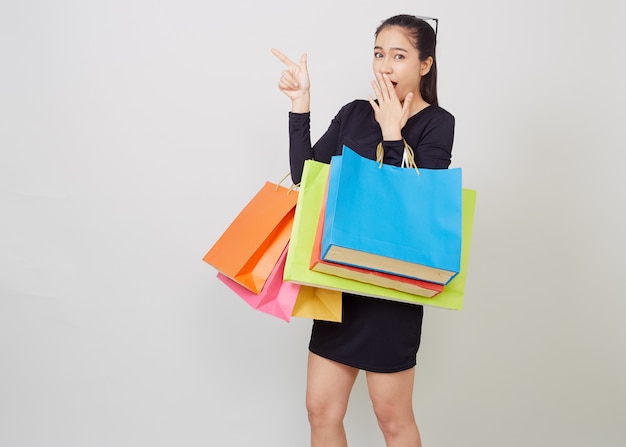 young asian woman with colorful shopping bags