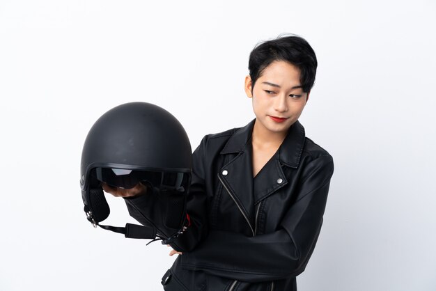 Young Asian woman with a motorcycle helmet with sad expression