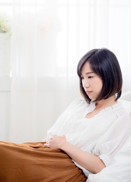 Young asian woman with stomachache