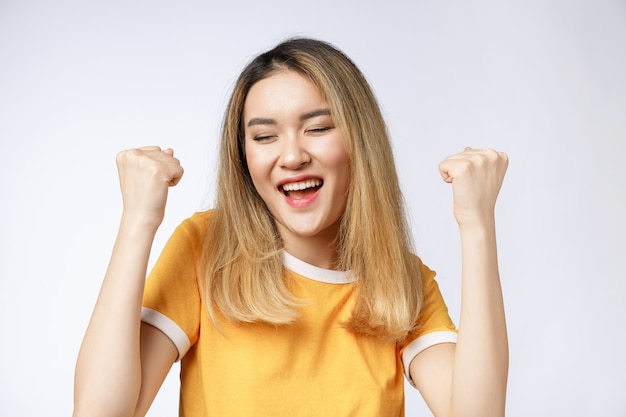 Young Asian woman with surprised excited happy screaming