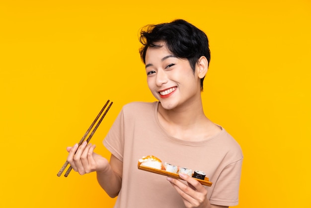 Young Asian woman with sushi