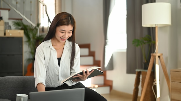 Young Asian woman working from home on a laptop