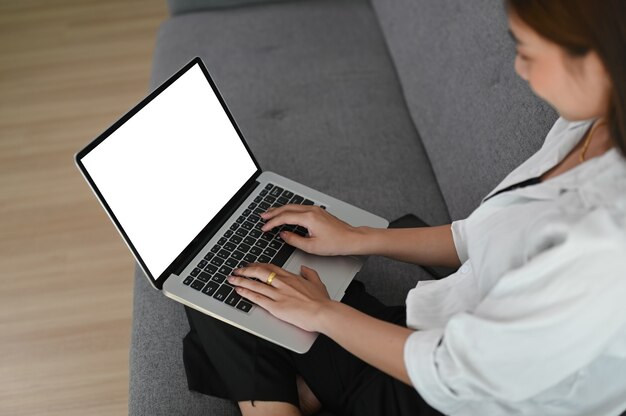 Young Asian woman working from home on a laptop