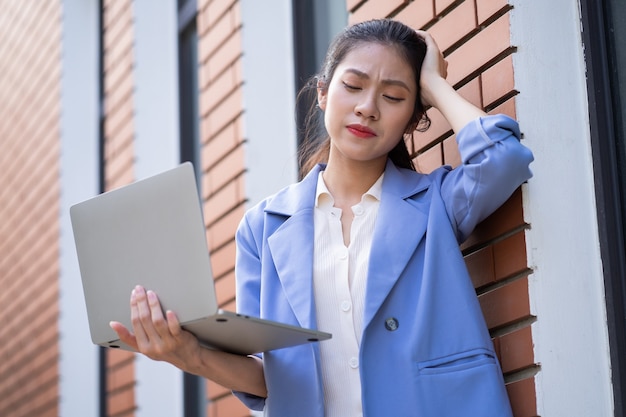 Young Asian woman working outside