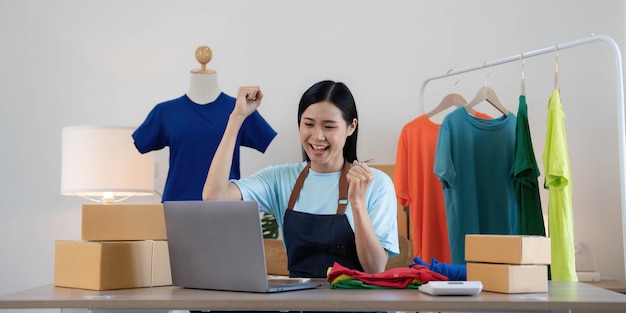 Young asian women happy after new order from customer surprise\
and shock face of asian woman success on making big sale of his\
online store online selling online shopping