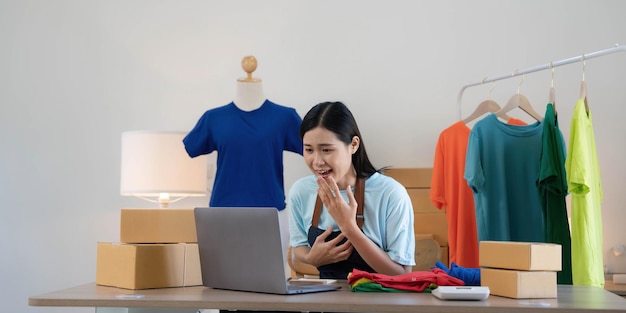 Young asian women happy after new order from customer surprise\
and shock face of asian woman success on making big sale of his\
online store online selling online shopping