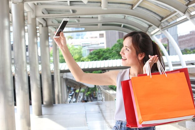 young asian women shopping at the mall taking a 