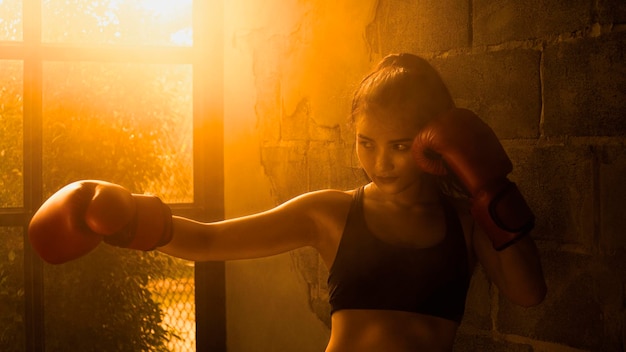 Young Asian women wearing boxing gloves.