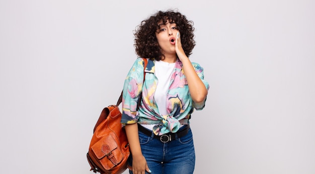 young astonished woman with curly hair