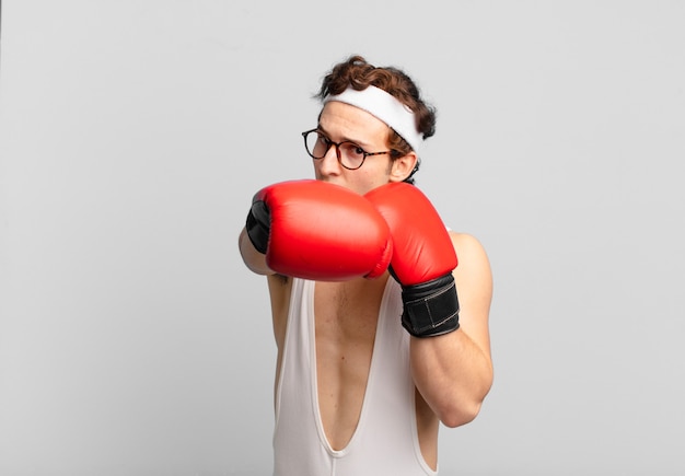 Young athlete angry expression boxing concept