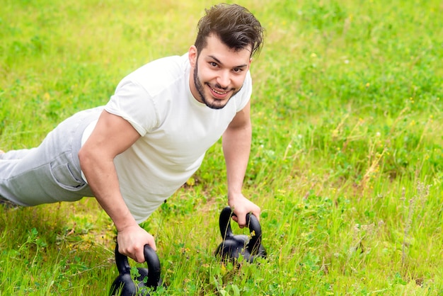 Young athlete does push-ups on green grass lawn at home simple and healthy lifestyle concept