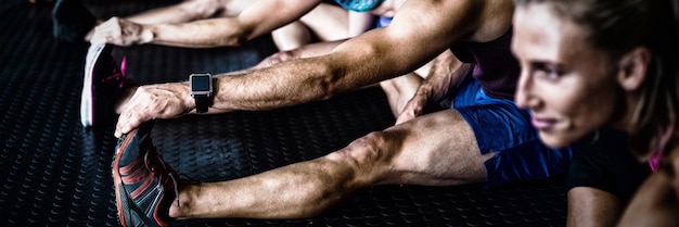 Young athlete friends stretching