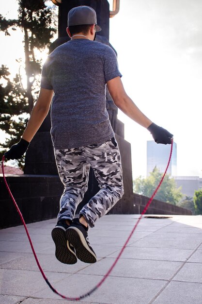 A young athlete jump rope on the street