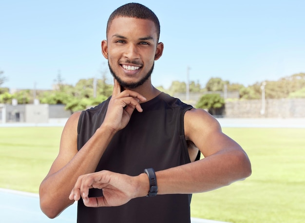 Young athlete using a fitness tracker to monitor progress heart rate and calories burned during a workout Portrait of a sportsman checking his pulse with a digital watch while training for exercise