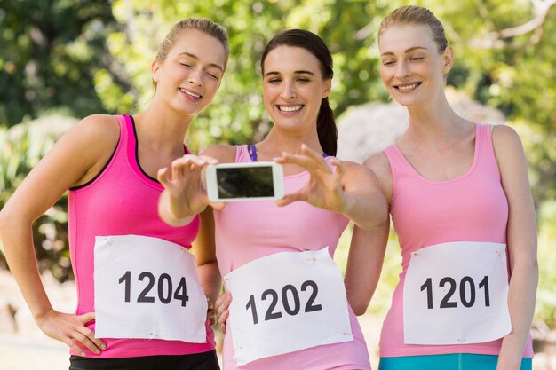 Young athlete women taking photo from mobile phone