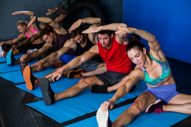 Young athletes doing stretching exercise