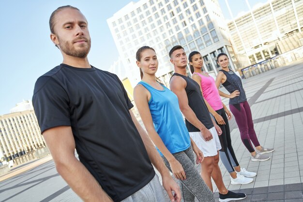 Young athletes standing in line and looking at camera