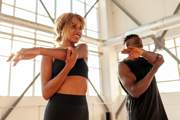 young athletic african american couple do exercises and warm up in the gym