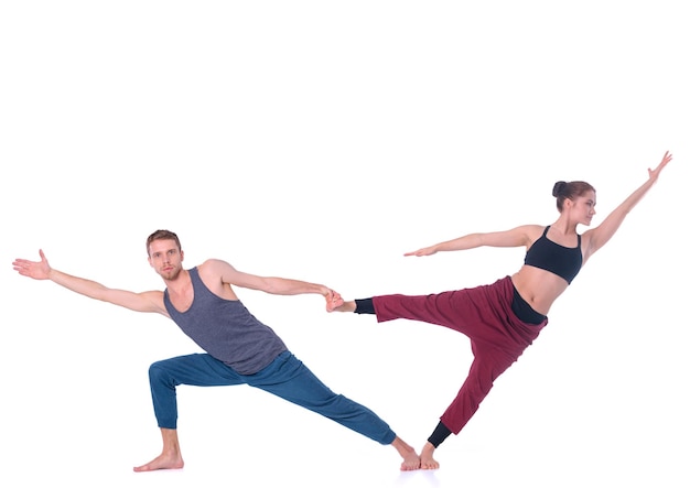 Young athletic couple practicing acroyoga Balancing in pair