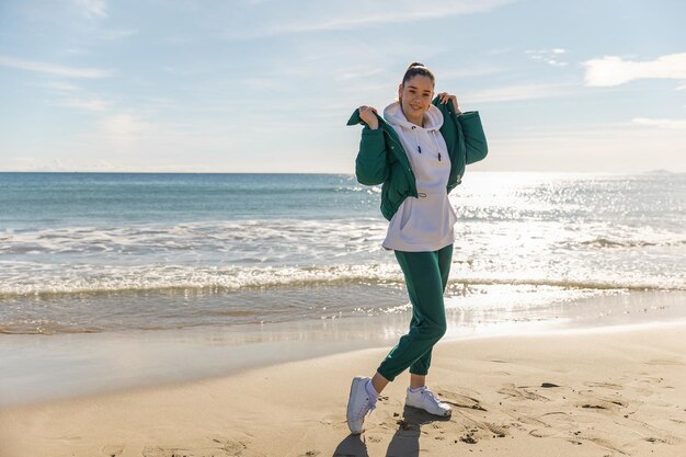 A young athletic girl against the backdrop of the sea