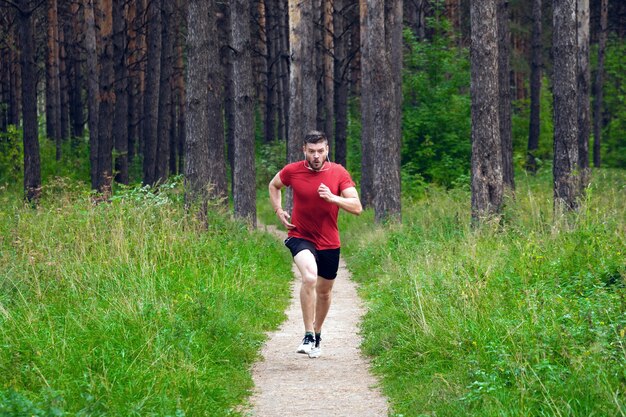 Young athletic man jogging in the park