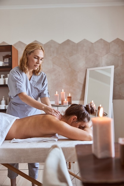 Young atractive female in massage salon is having beauty and healthcare procedures