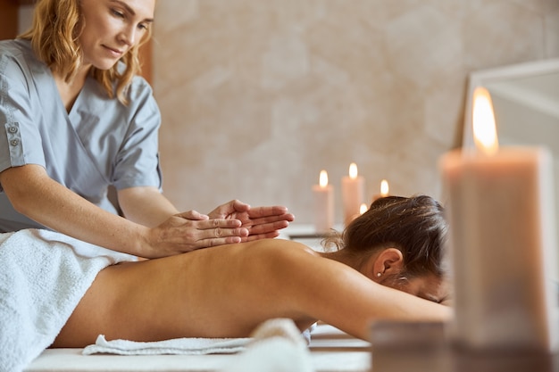 Young atractive female in massage salon is having beauty and healthcare procedures