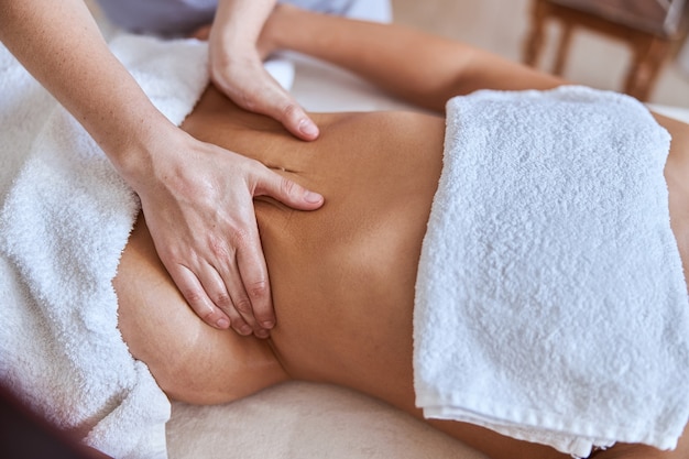 Young atractive female in massage salon is having beauty and healthcare procedures