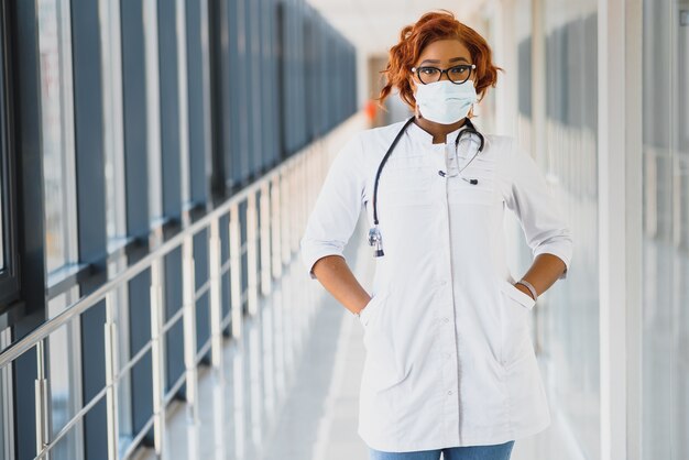 Young attractive african doctor with face mask