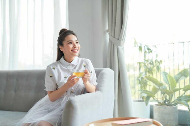 Young attractive asian woman who drink tea