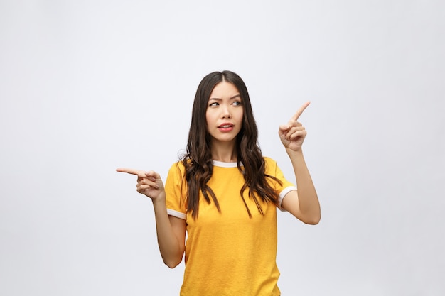 Young attractive asian woman who points to the finger with unhappy emotion