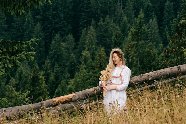 Young attractive blonde woman white dress