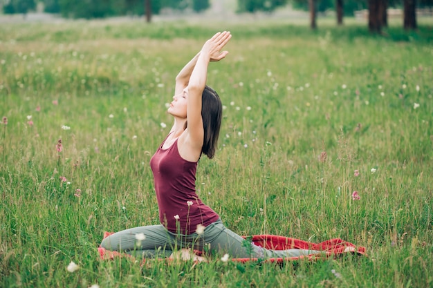 Young attractive brunette girl doing exercises