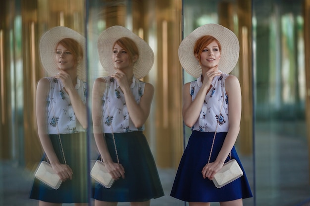 Young attractive cheerful woman walking in city. Woman against the backdrop of an interesting concert hall in Moscow in Zaryadye park