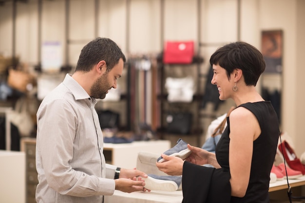 a young attractive couple changes the look with new shoes  at shoe store