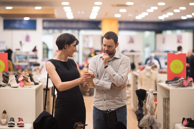 A young attractive couple changes the look with new shoes  At Shoe Store