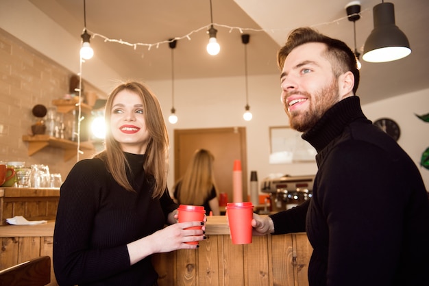 Young attractive couple on date in coffee shop.