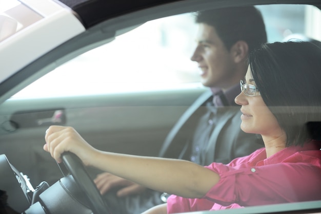 Young attractive couple driving in a car