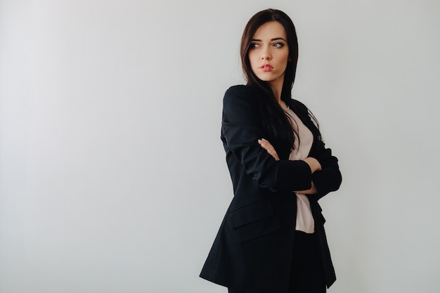 Young attractive emotional woman in business-style clothing