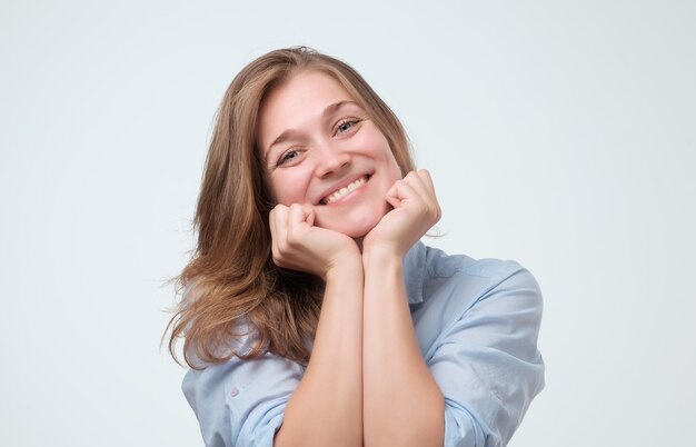 Young attractive european woman smiling warmly and friendly while listening to you