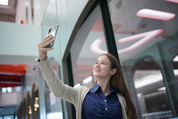 Young attractive female using a mobile phone for social media and using new online 5G technology app