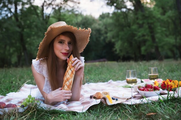 Young attractive girl on a picnic in a city park.