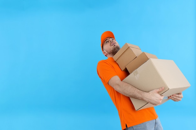 Young attractive guy with cardboard boxes in hands