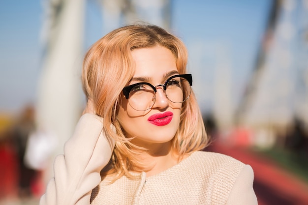 Young attractive model wears clear glasses with bright makeup 