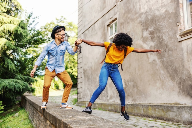 Young attractive multiracial couple having fun outdoors.