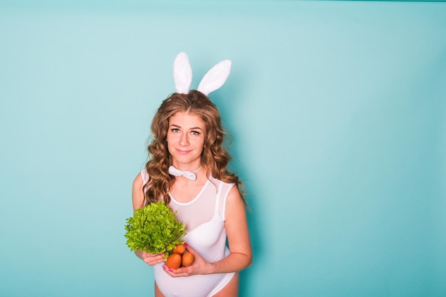 Young attractive pregnant girl in a bunny suit