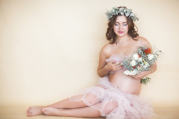 Young attractive pregnant woman at home. close up portrait of expecting female.