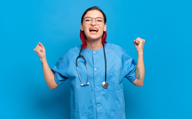 Young attractive red hair woman shouting aggressively