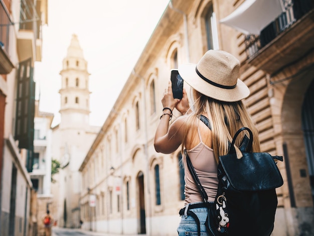 young attractive smiling girl tourist exploring new city at summer