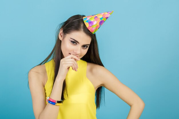 Young attractive smiling woman with a birthday hat